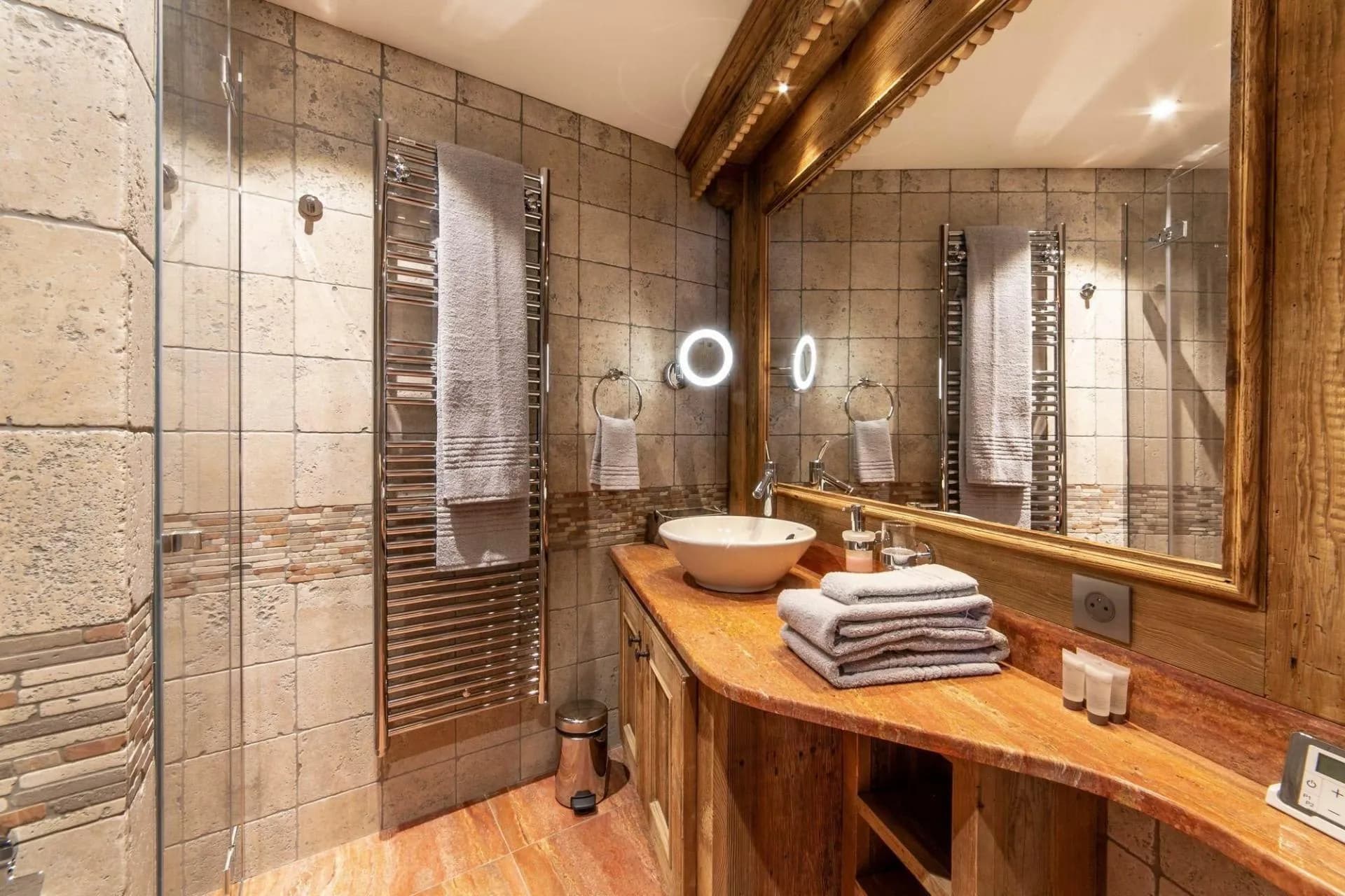 Bathroom with stone basin and glass shower screen