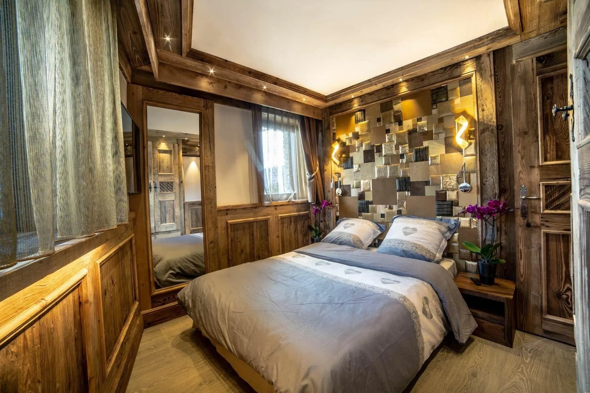 Double bedroom with patterned wall and large window