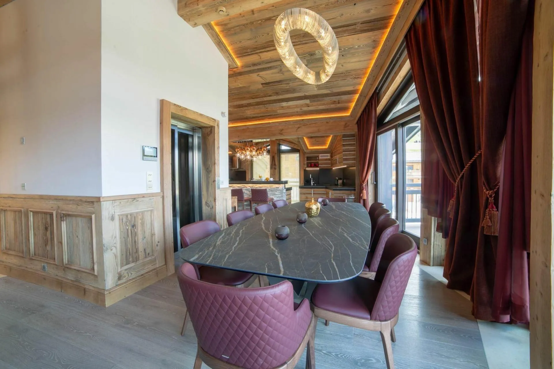 Dining table with upholstered seating and timber ceiling