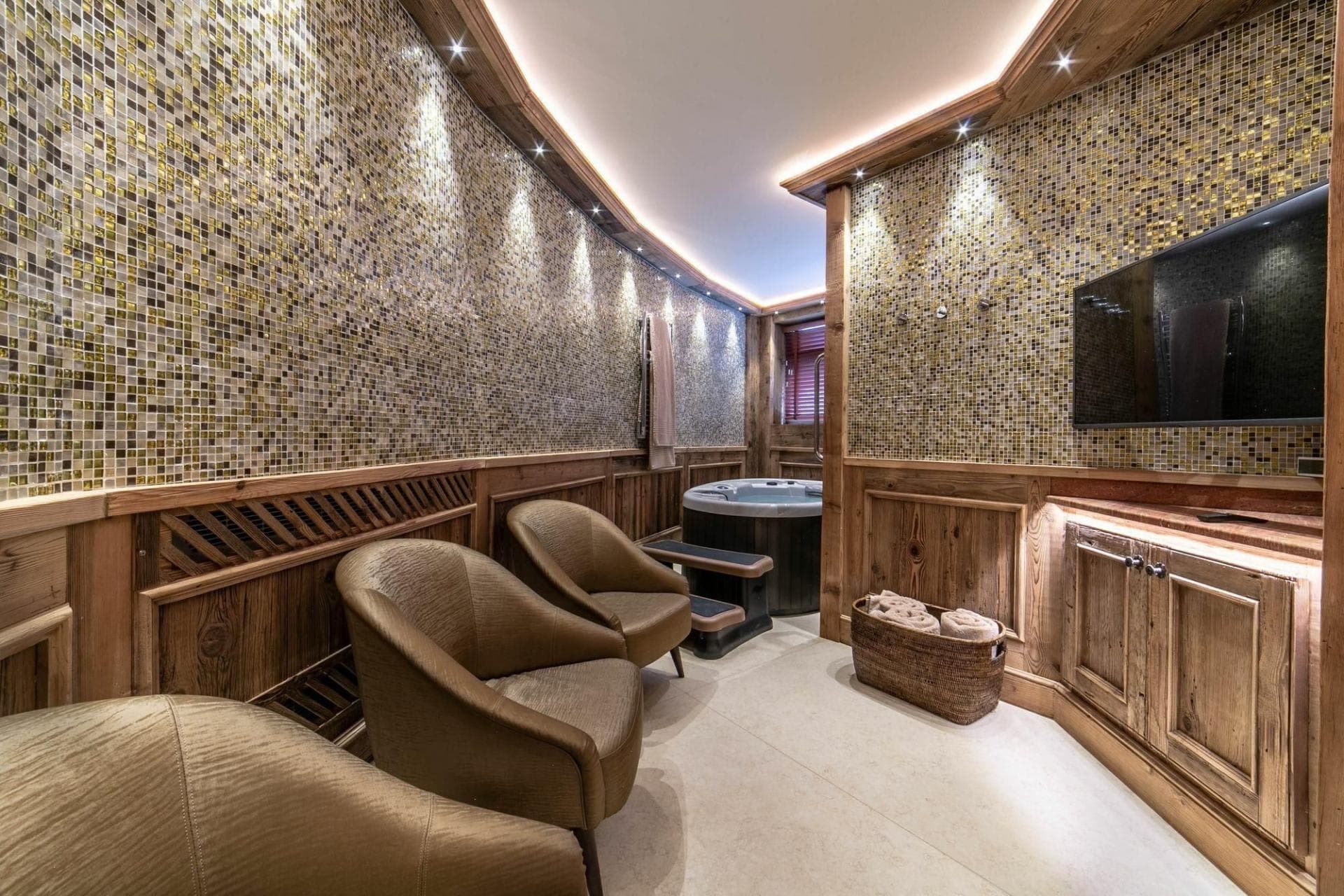 Indoor spa with round hot tub and wall-mounted TV