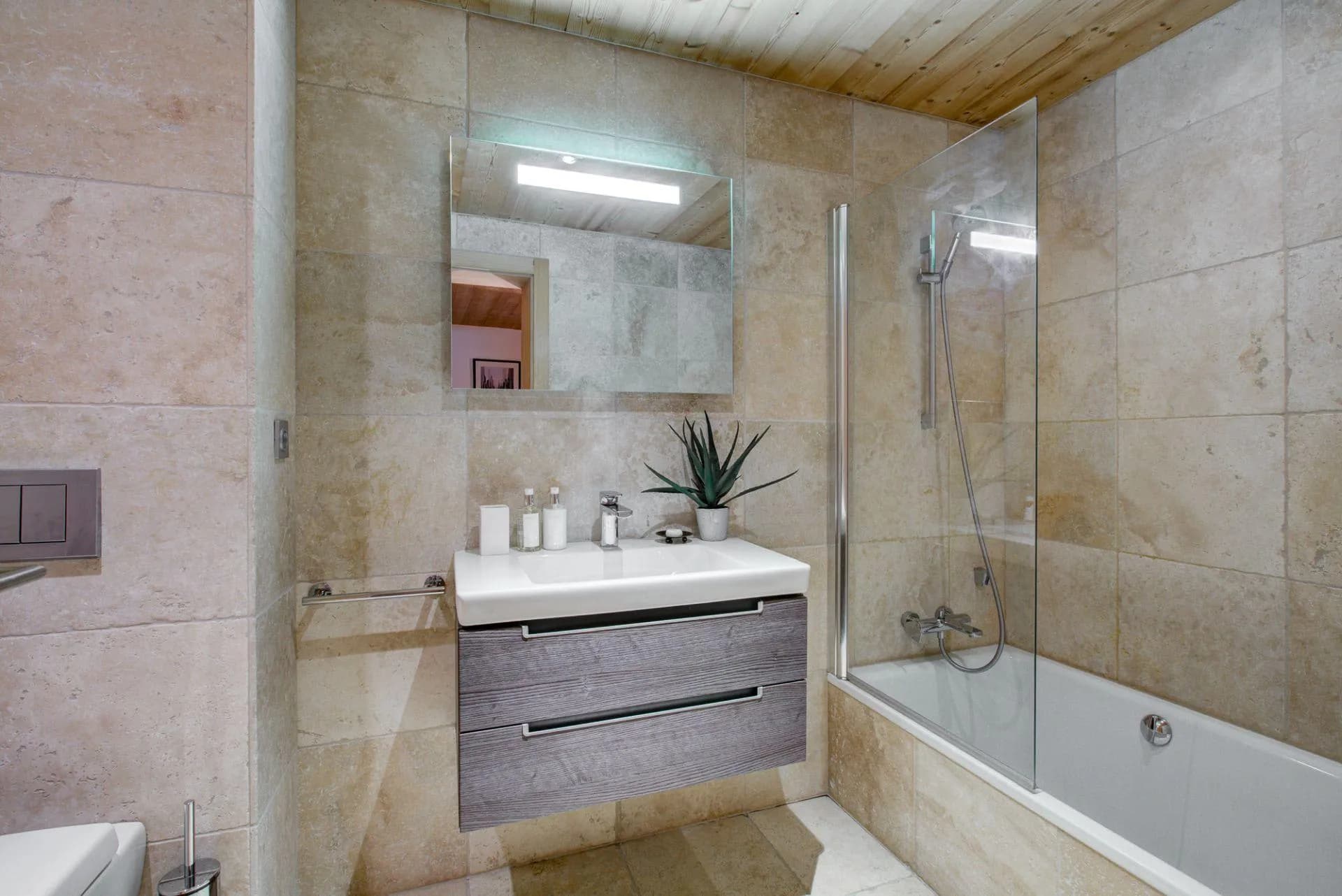 En-suite bathroom with bath and power shower