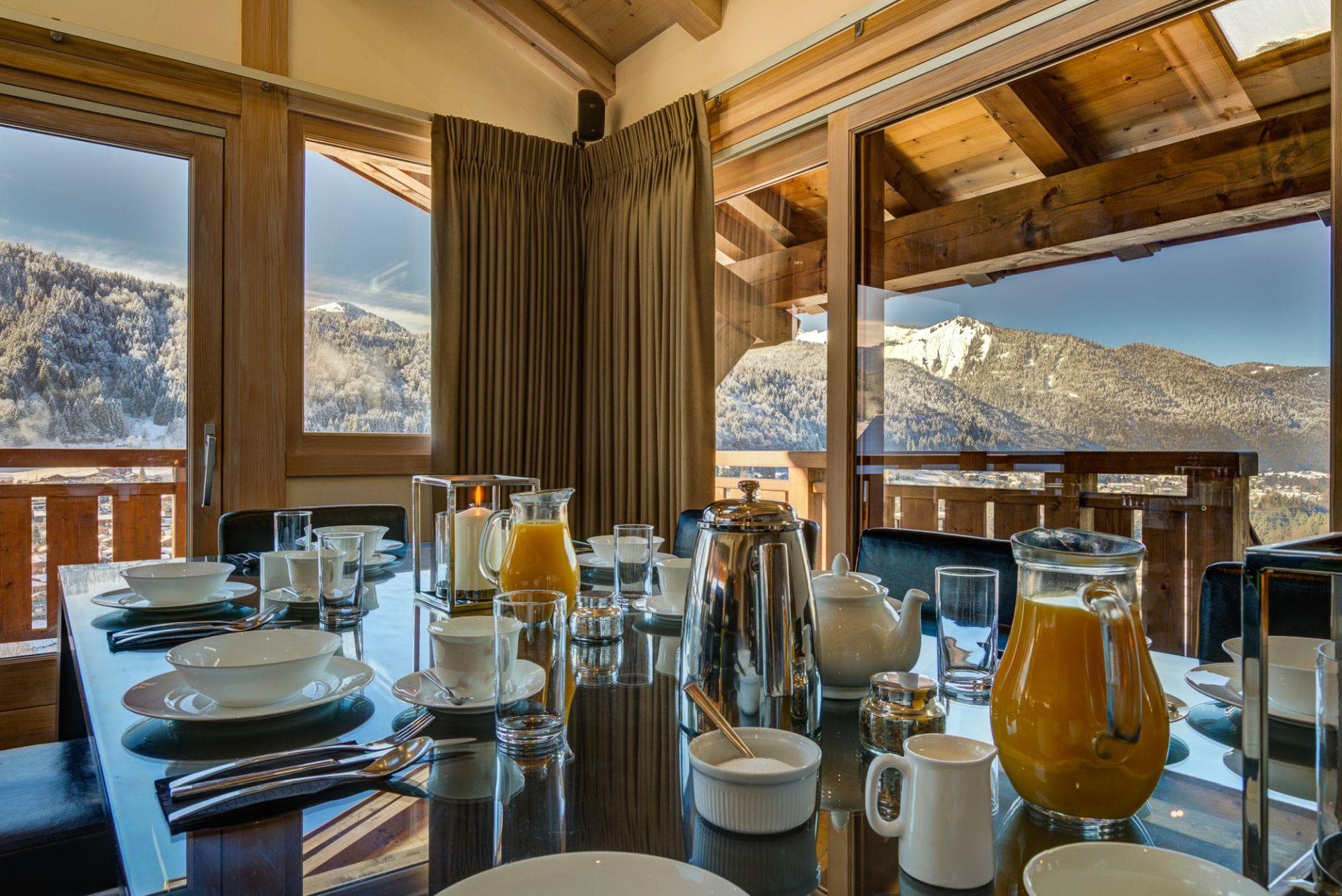 Dining area with floor-to-ceiling windows and mountain views