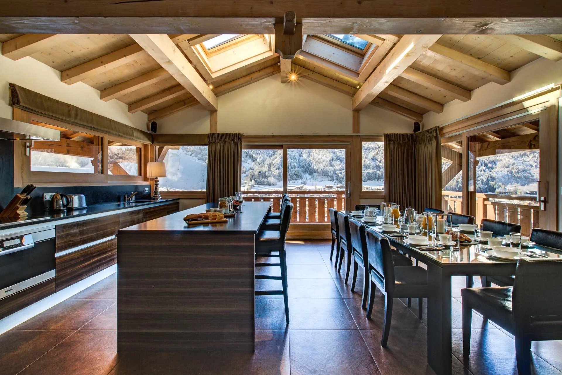 Dining table for ten beside the open-plan kitchen