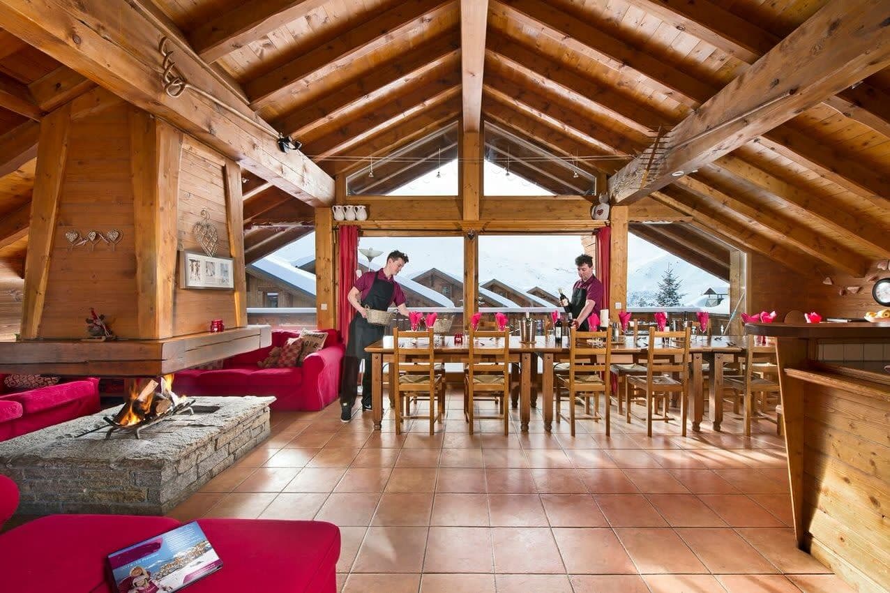 Open-plan dining area with 10-person table and wood-burning fireplace