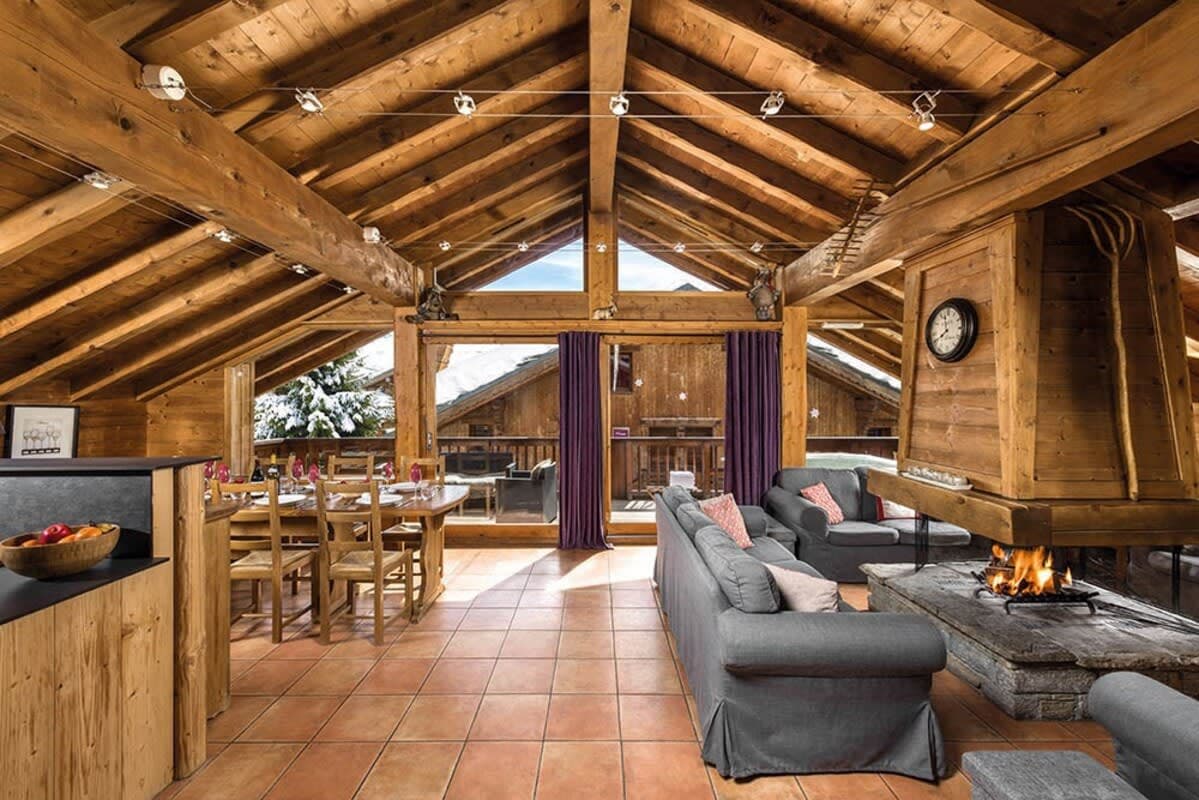 Open-plan living area with wood-burning fireplace and dining table for eight