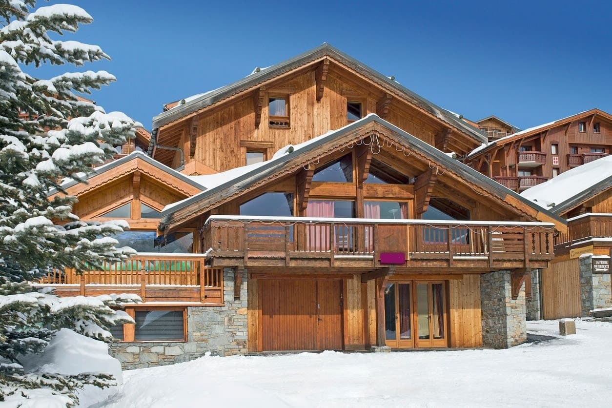 Ski chalet exterior featuring private balcony and garage for gear storage