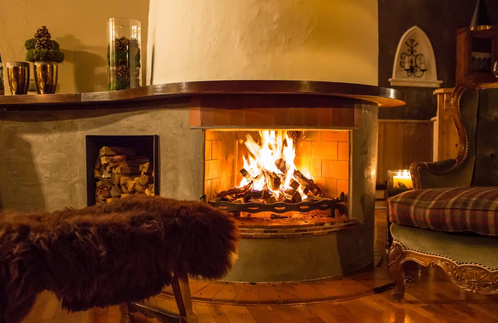 Wood-burning fireplace with integrated log storage and fireside seating