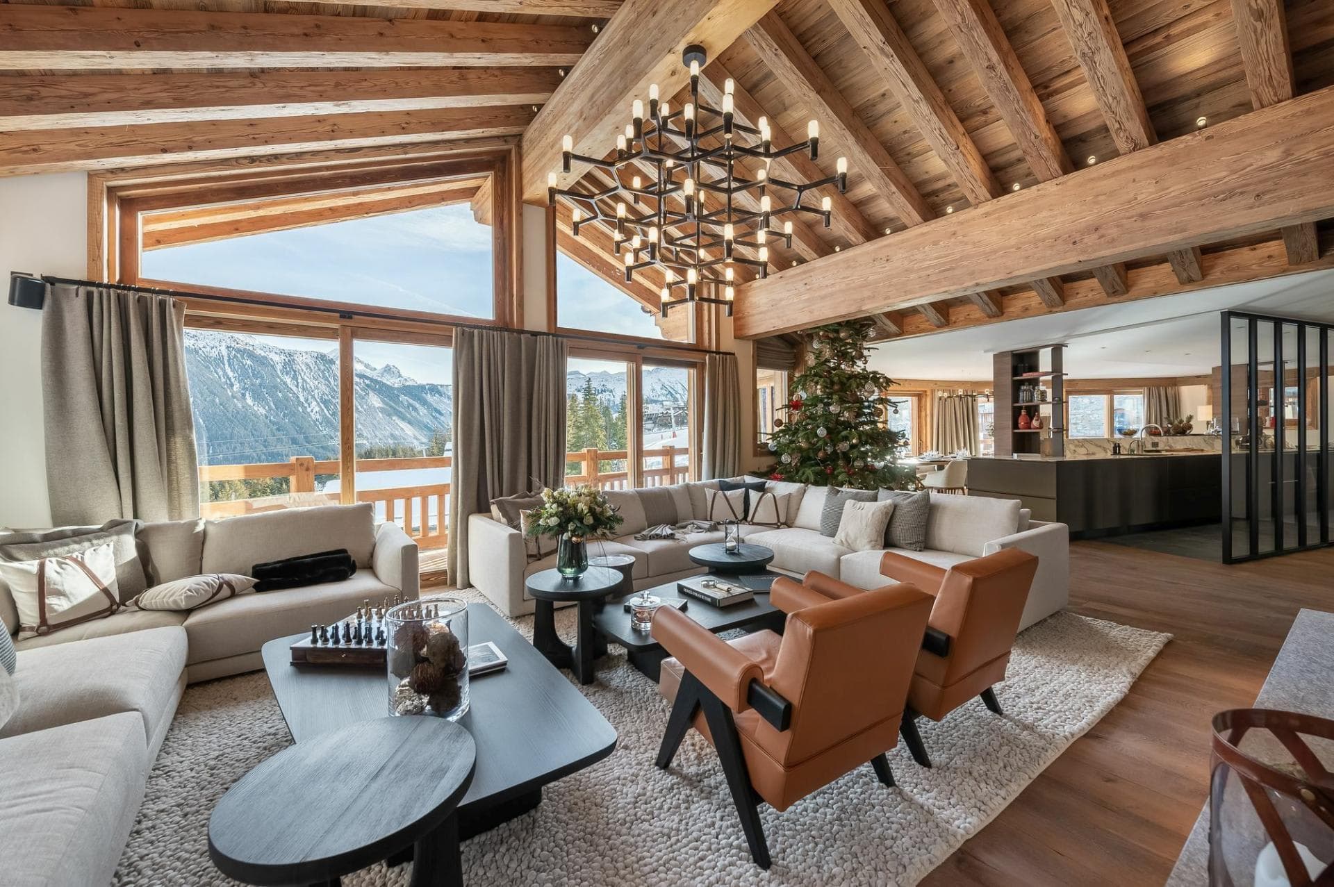 Living area with vaulted timber ceilings and floor-to-ceiling mountain views