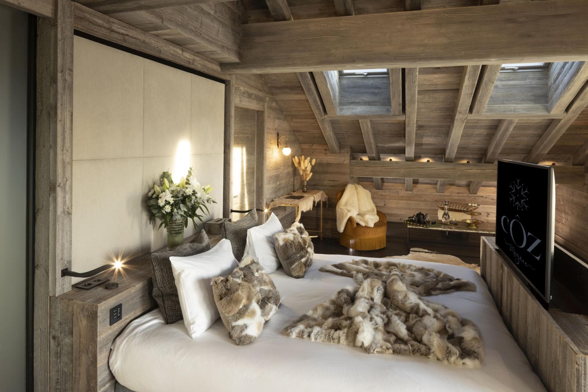 Attic bedroom with pop-up television and skylights