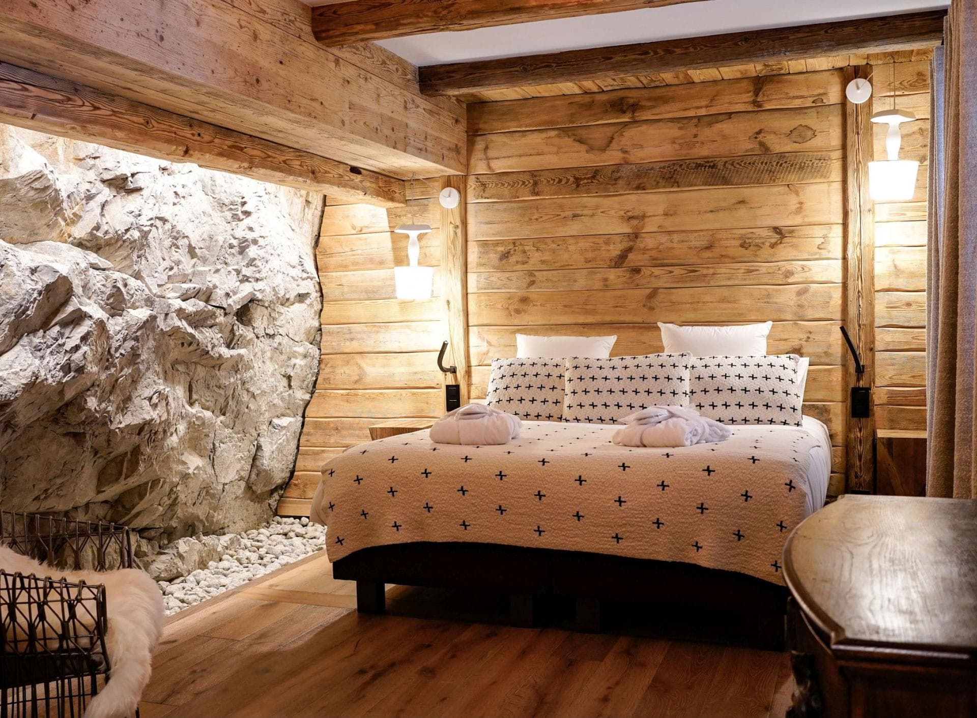 Bedroom with king bed and exposed natural rock wall