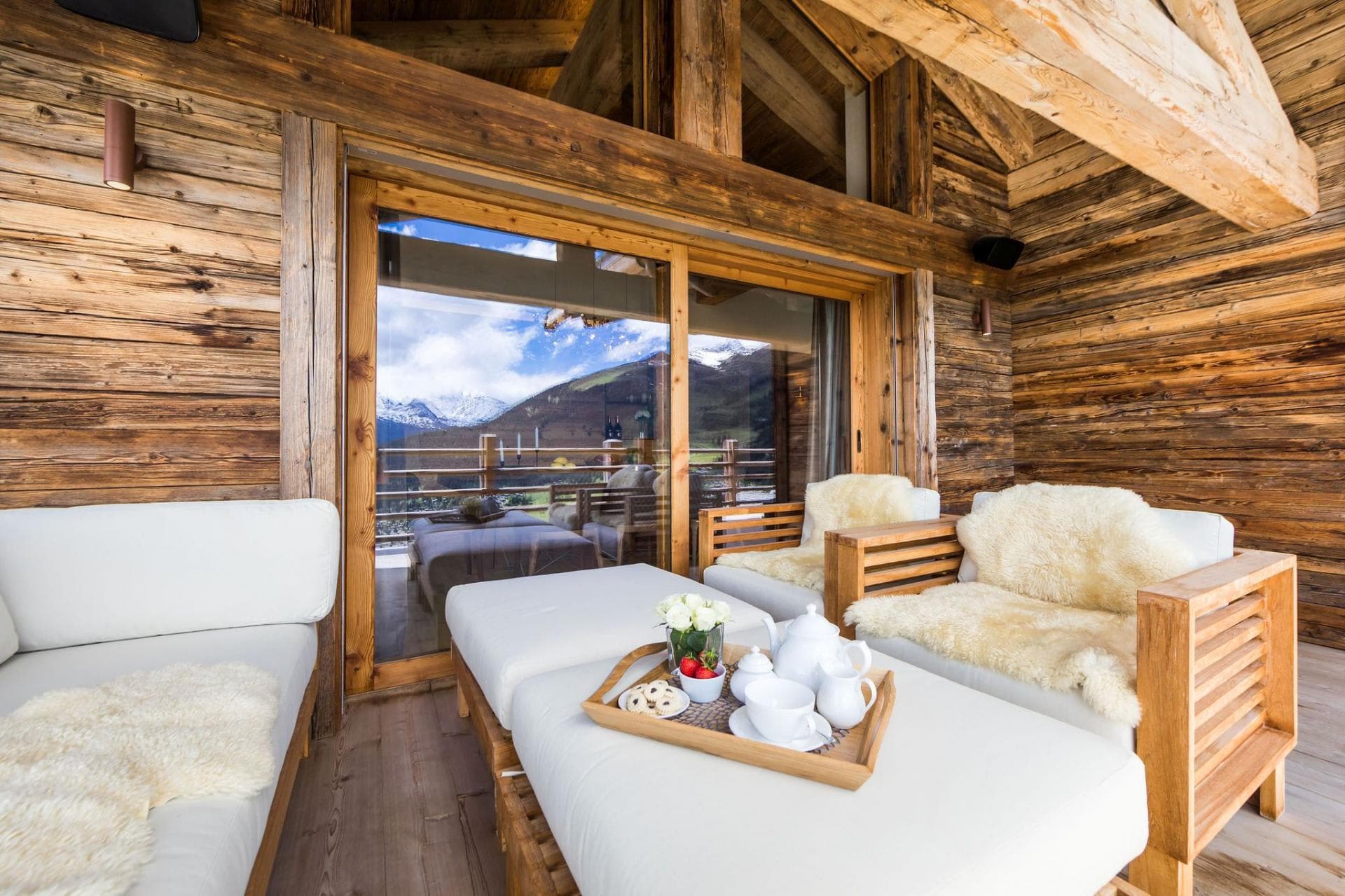 Covered timber balcony with lounge seating and mountain views
