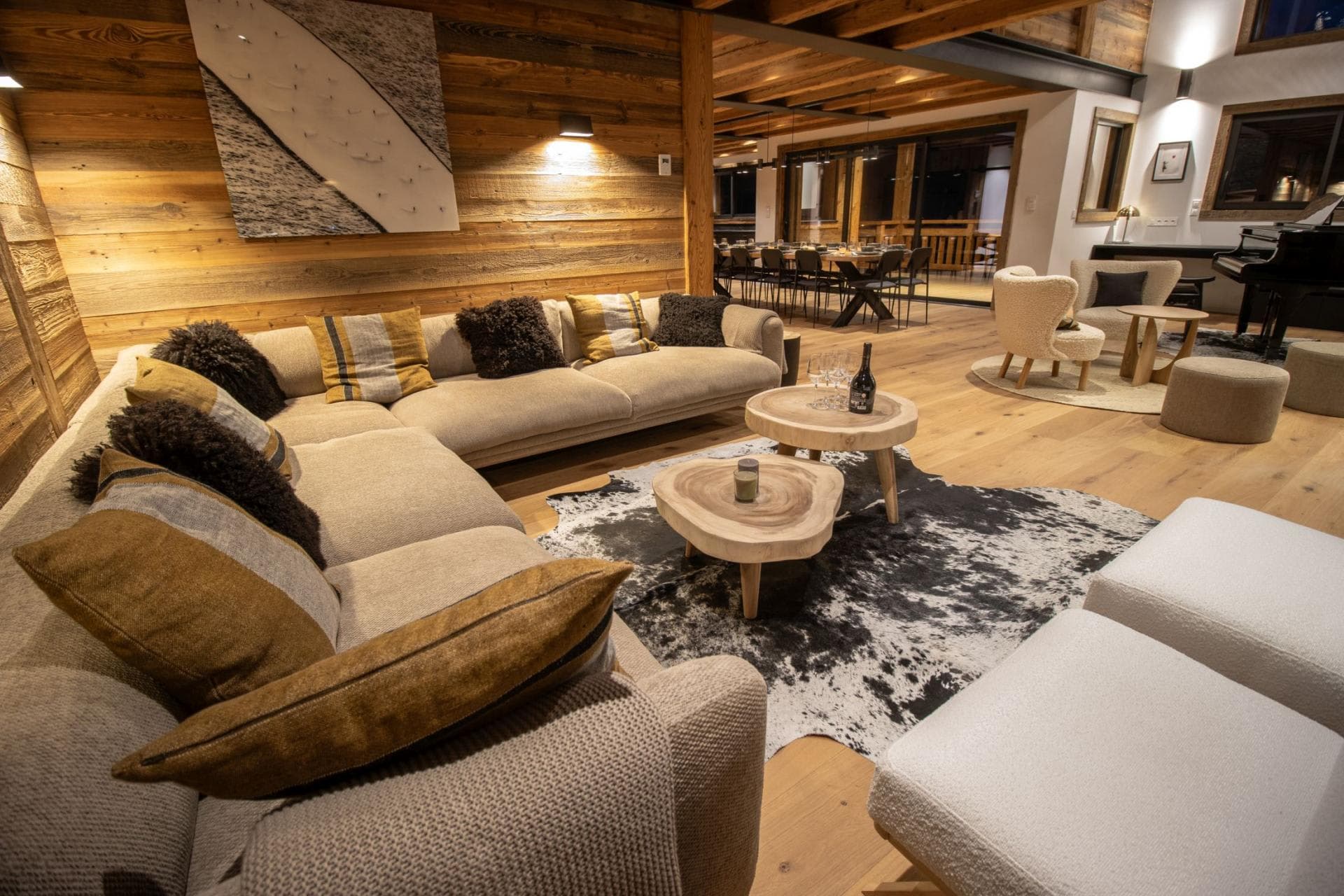 Open living area with sectional seating and grand piano