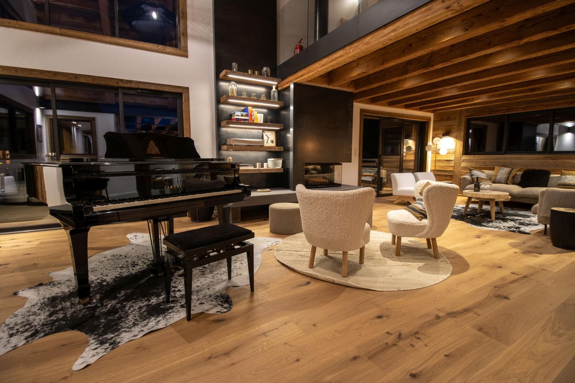 Open living area with grand piano and wood-burning fireplace