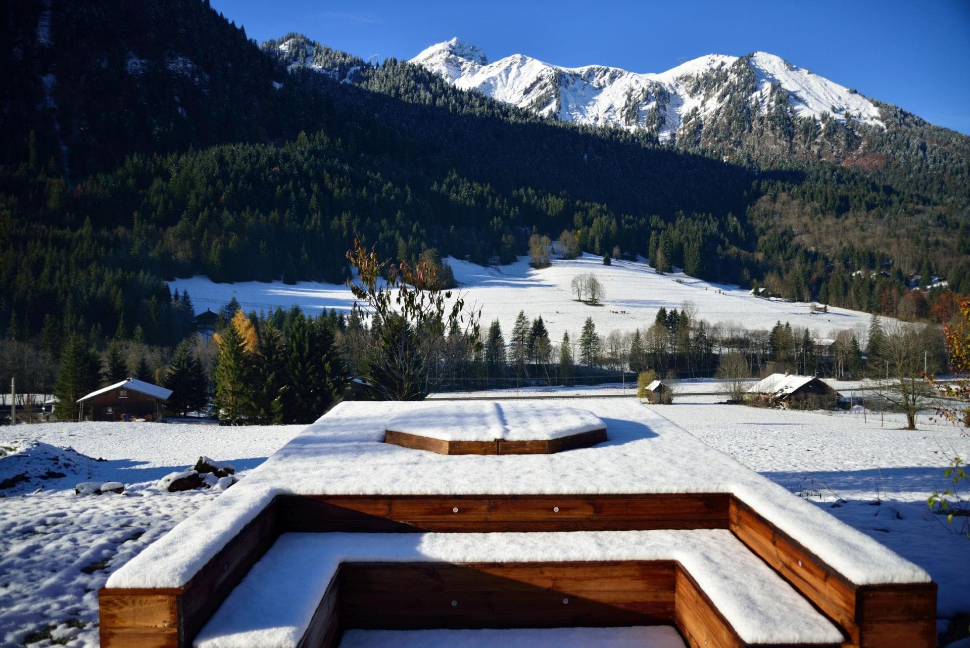 Outdoor hot tub and sun deck with panoramic Alpine valley views