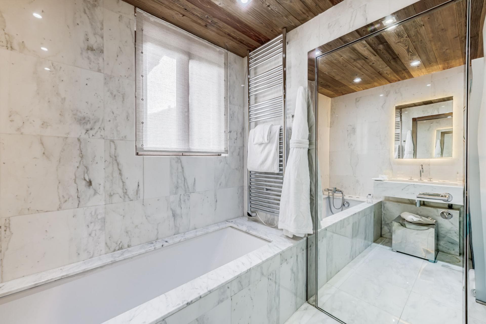 Marble bathroom with soaking tub and heated towel rail