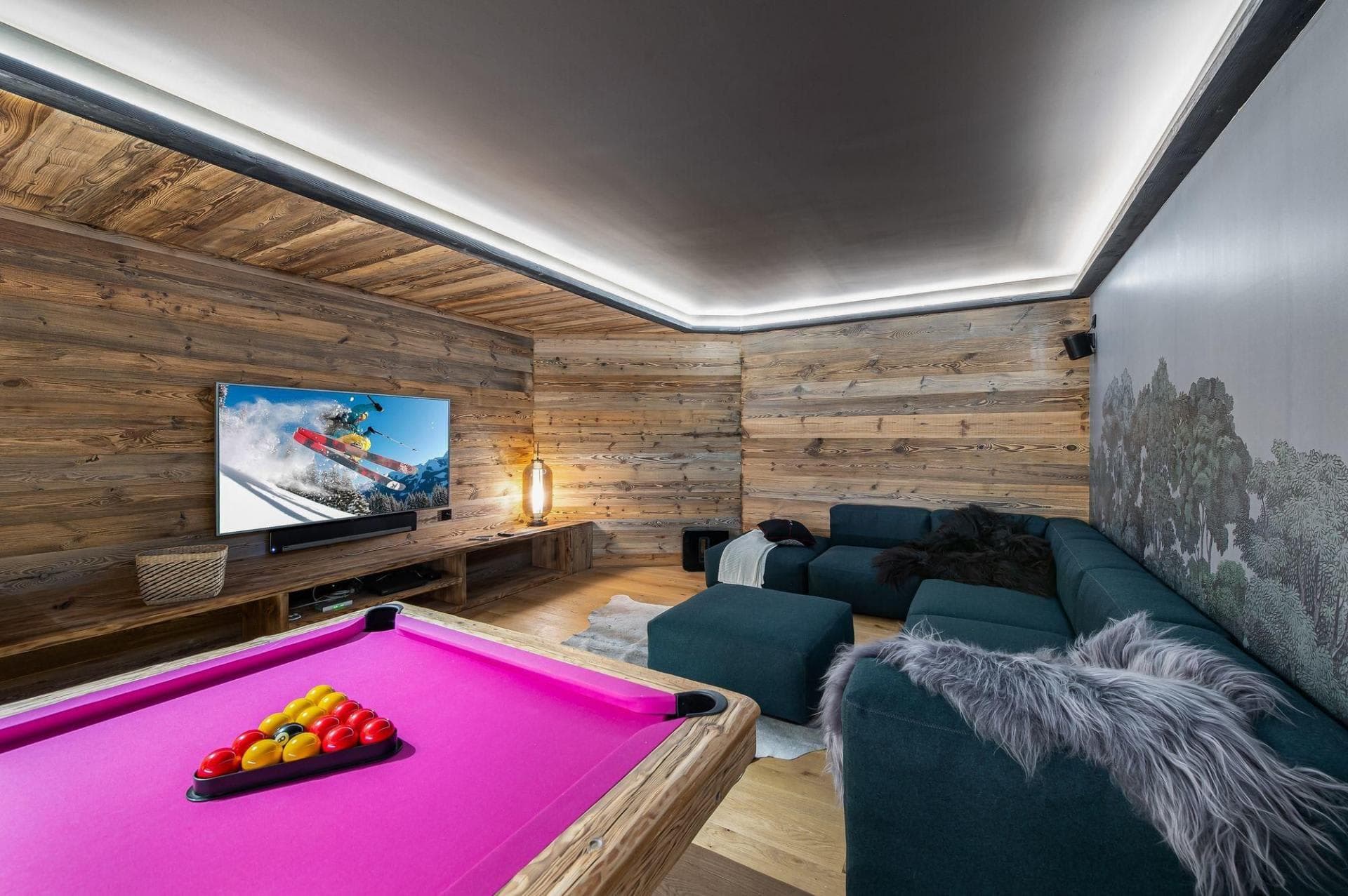 Media room with pool table, large-screen TV, and sectional seating