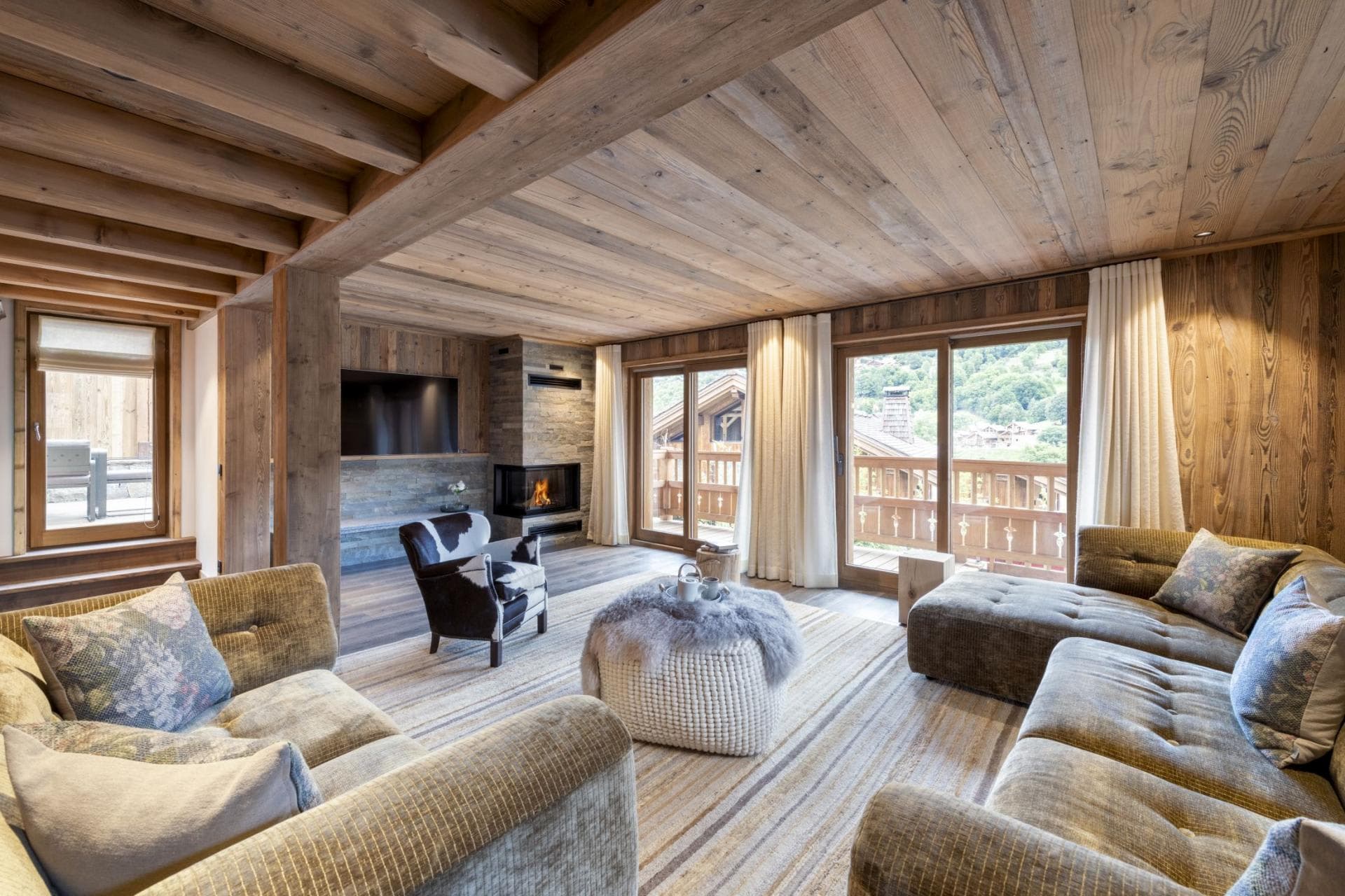 Living area with wood-burning fireplace and balcony access