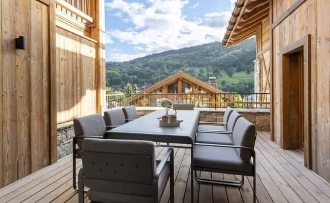 Covered balcony dining area for 8 with valley views