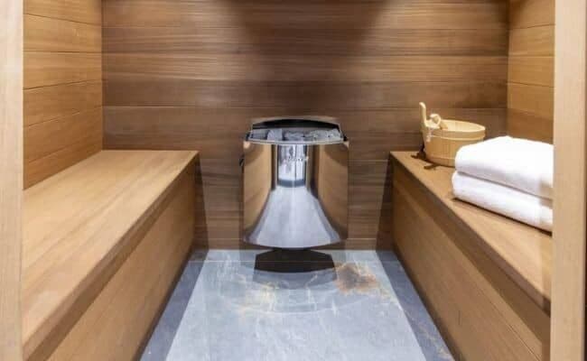 Cedar sauna with stone heater and bench seating for 4