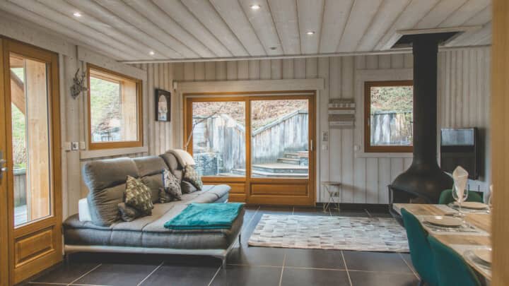 Living area with wood-burning stove and sliding glass doors to patio