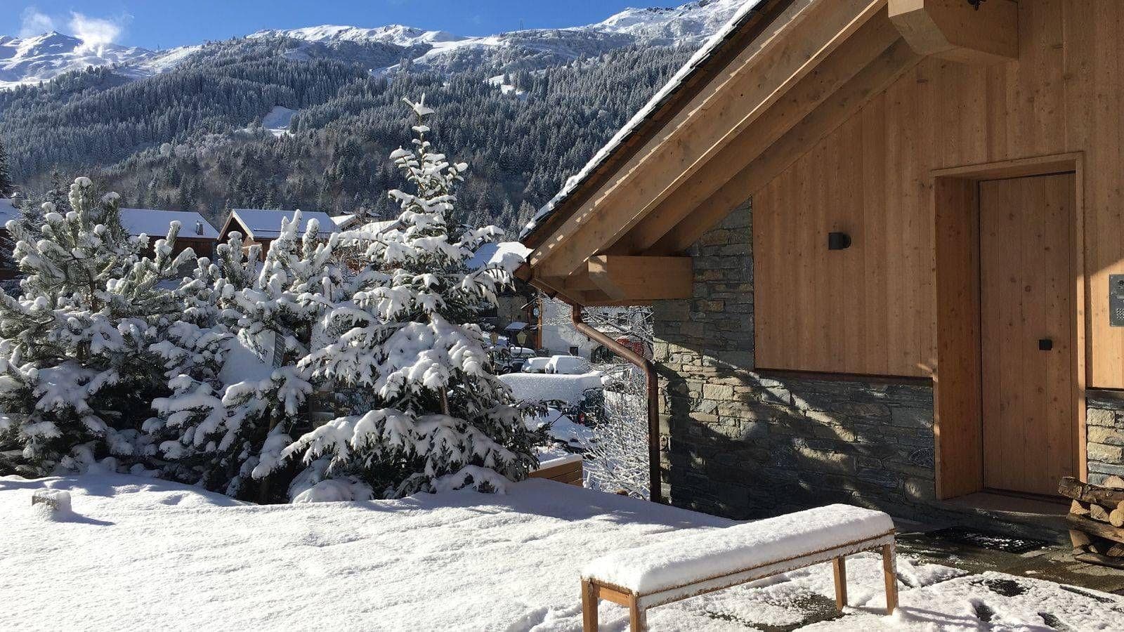 Chalet entrance with stone facade and mountain views