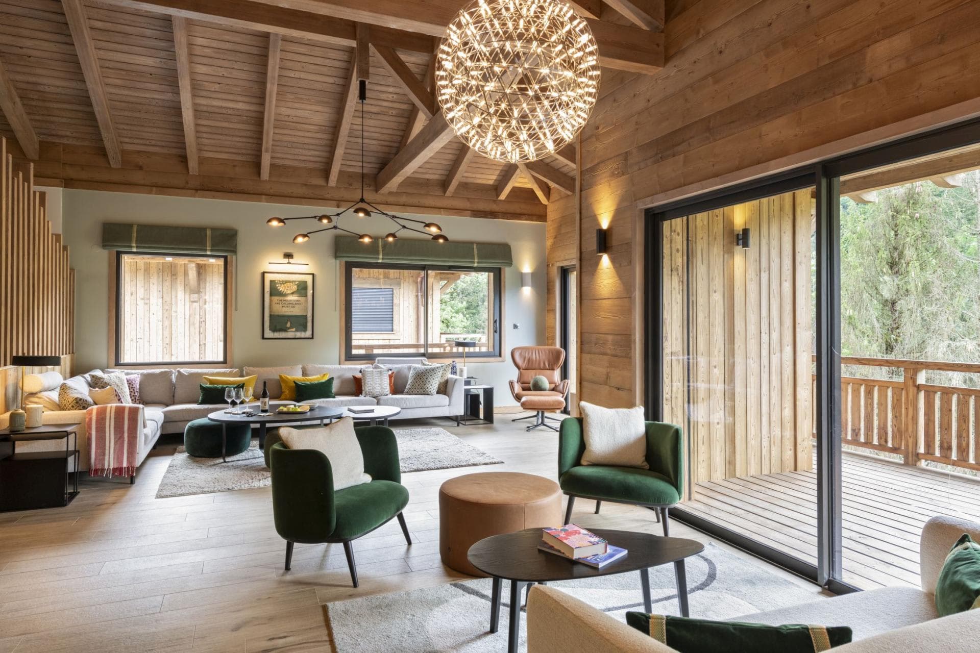 Living area with vaulted timber ceilings and sliding doors to balcony