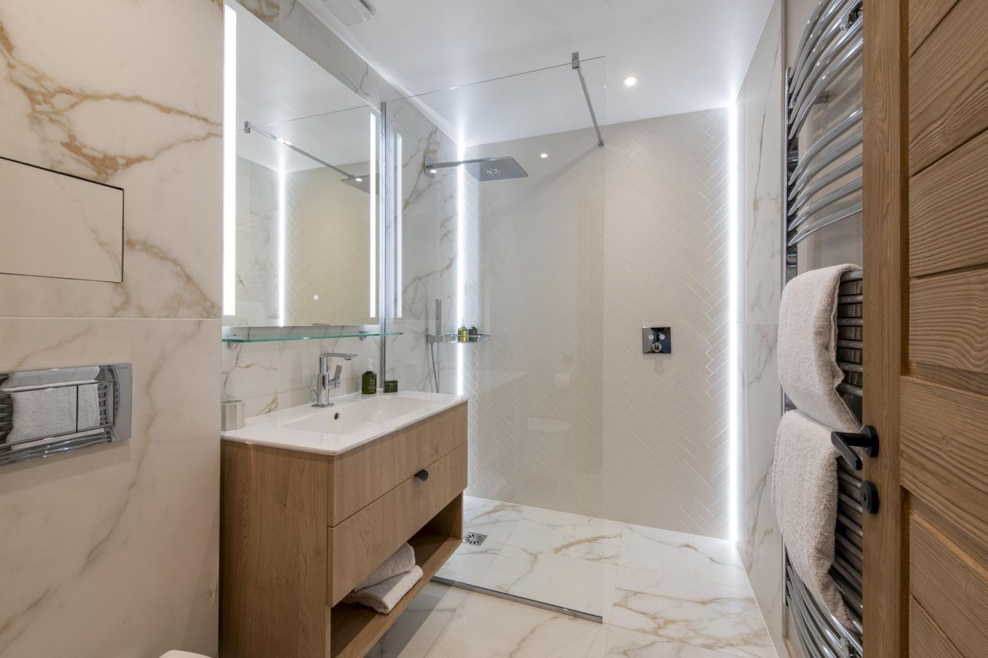 Bathroom with walk-in rainfall shower and heated towel rack