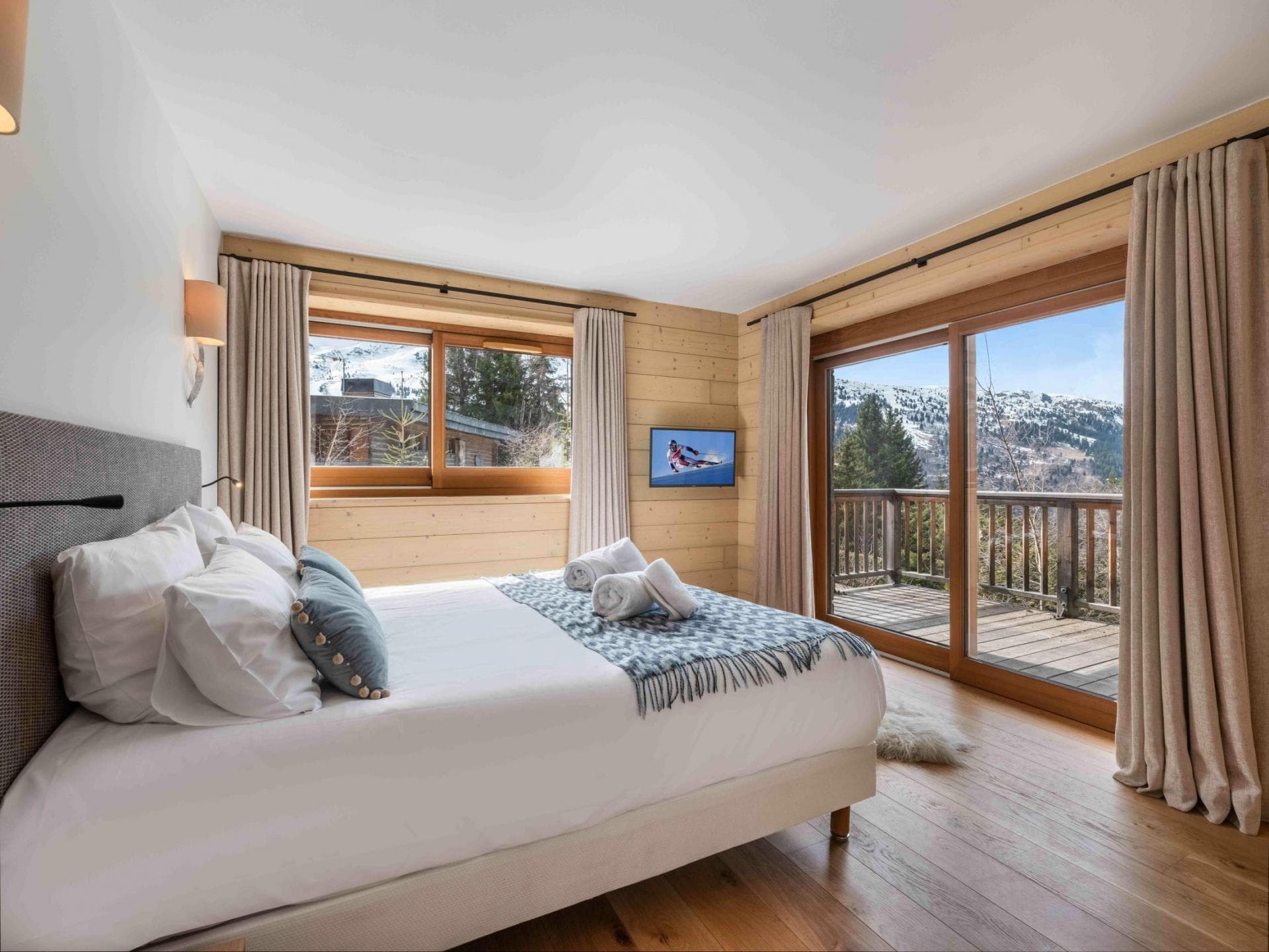 Bedroom with king bed and private balcony; mountain views