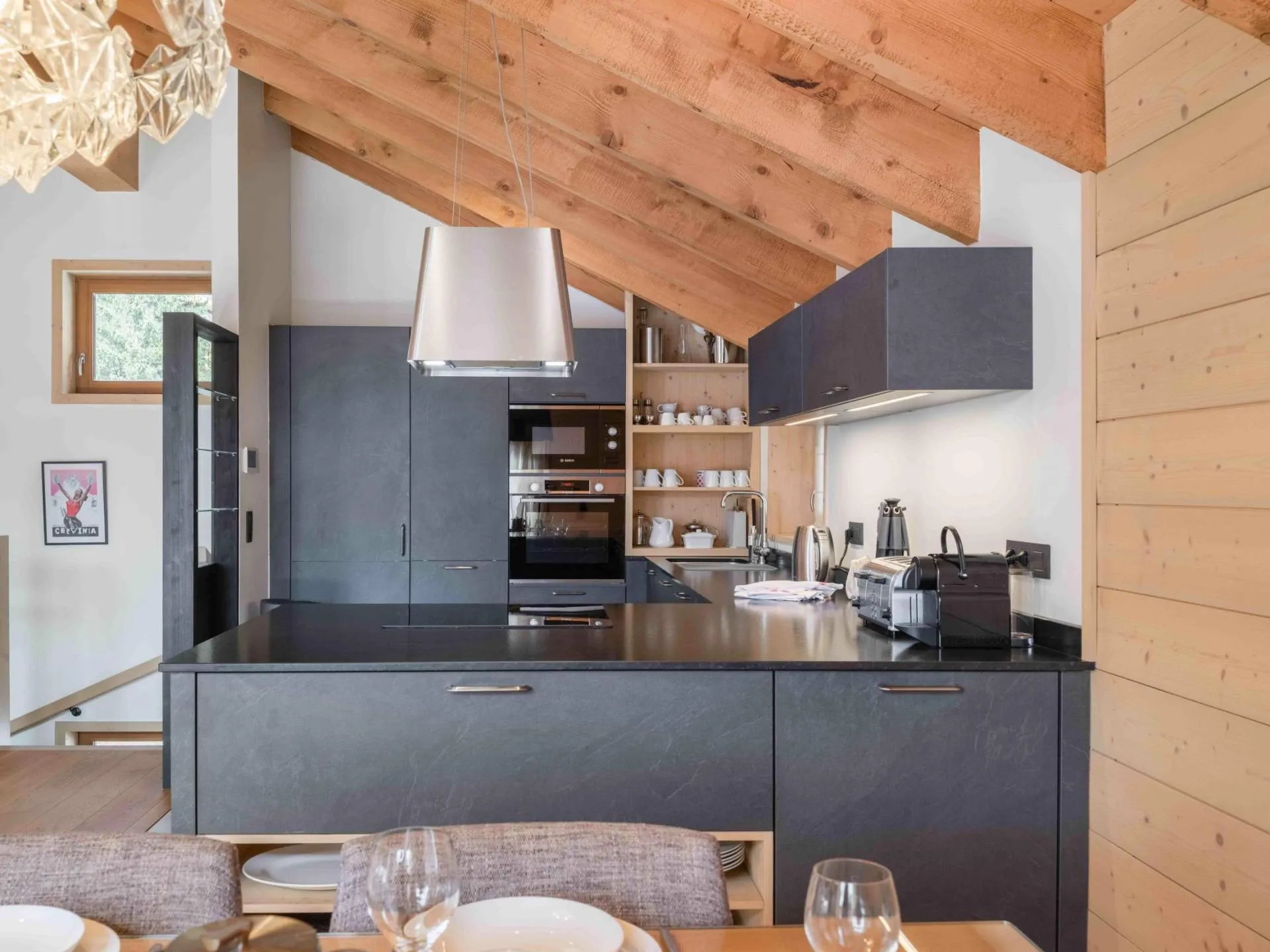 Open kitchen beneath vaulted timber beams