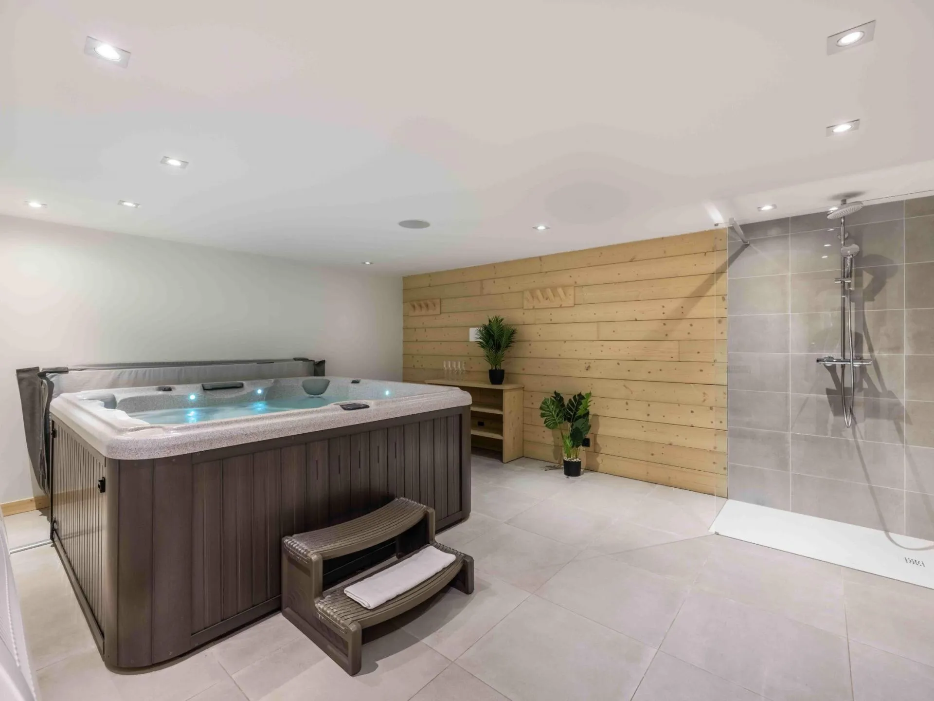 Indoor hot tub beside a walk-in shower