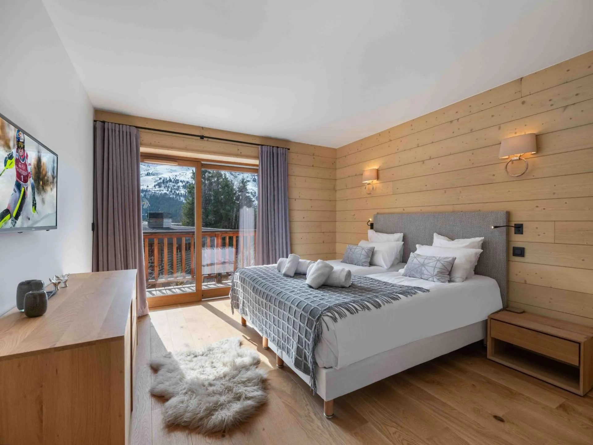 Double or twin bedroom with timber panelling and mountain views