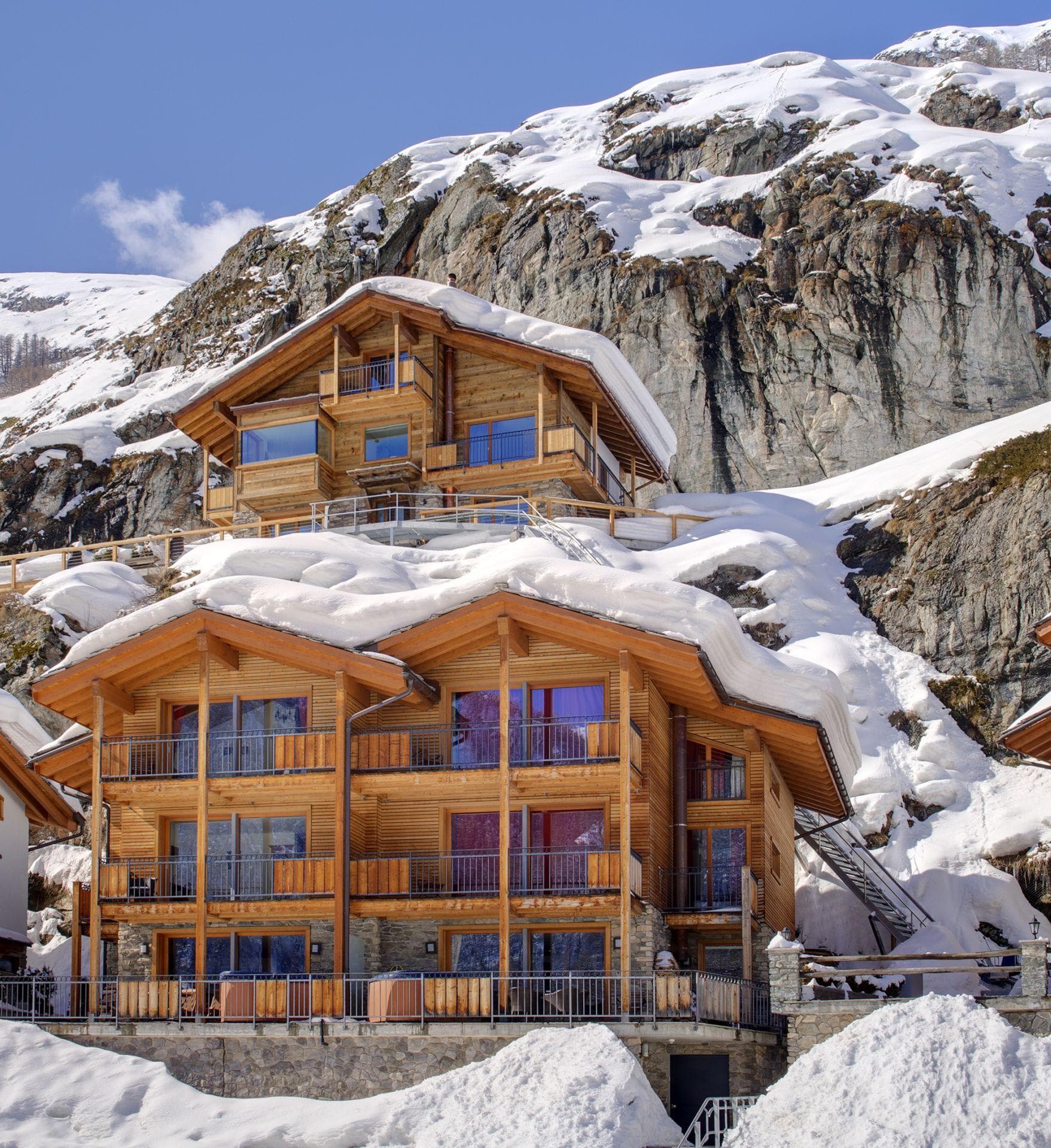 Mountain chalet exterior with private balconies and outdoor hot tubs