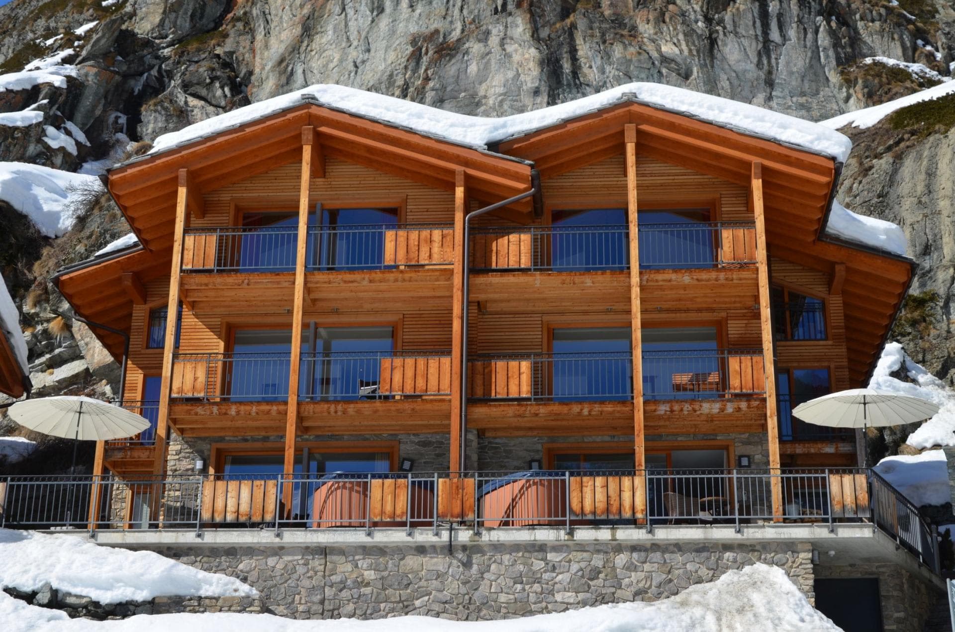 Chalet exterior with private balconies and two terrace hot tubs