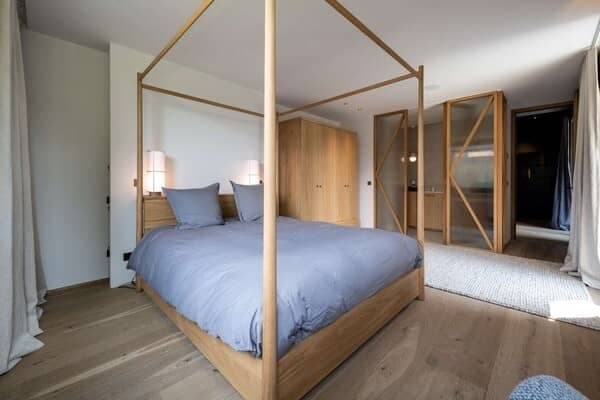 Primary bedroom with four-poster king bed and built-in wardrobe