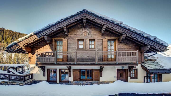 Chalet exterior with full-width balcony and traditional wooden shutters