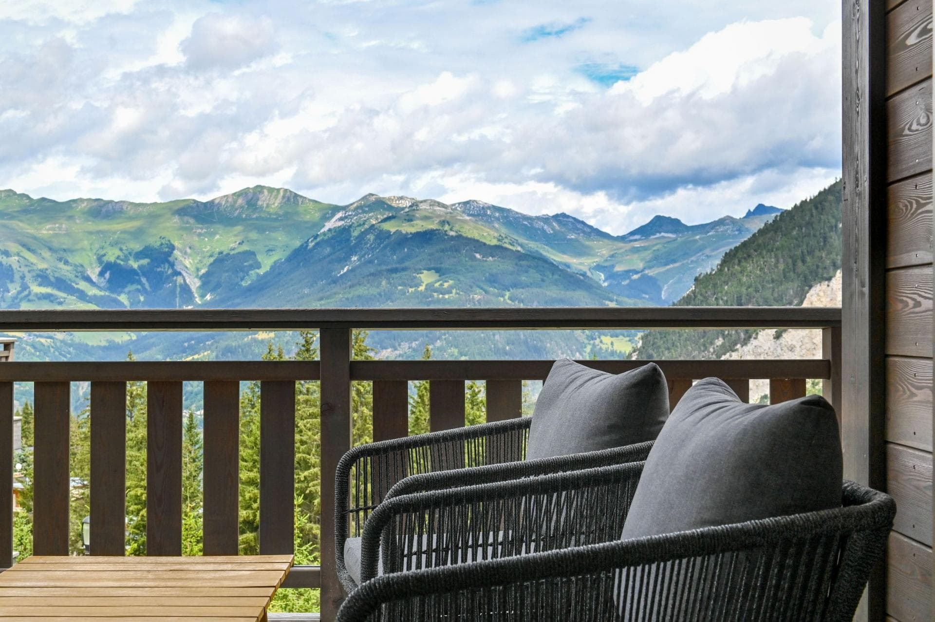 Private balcony with lounge seating and panoramic mountain views