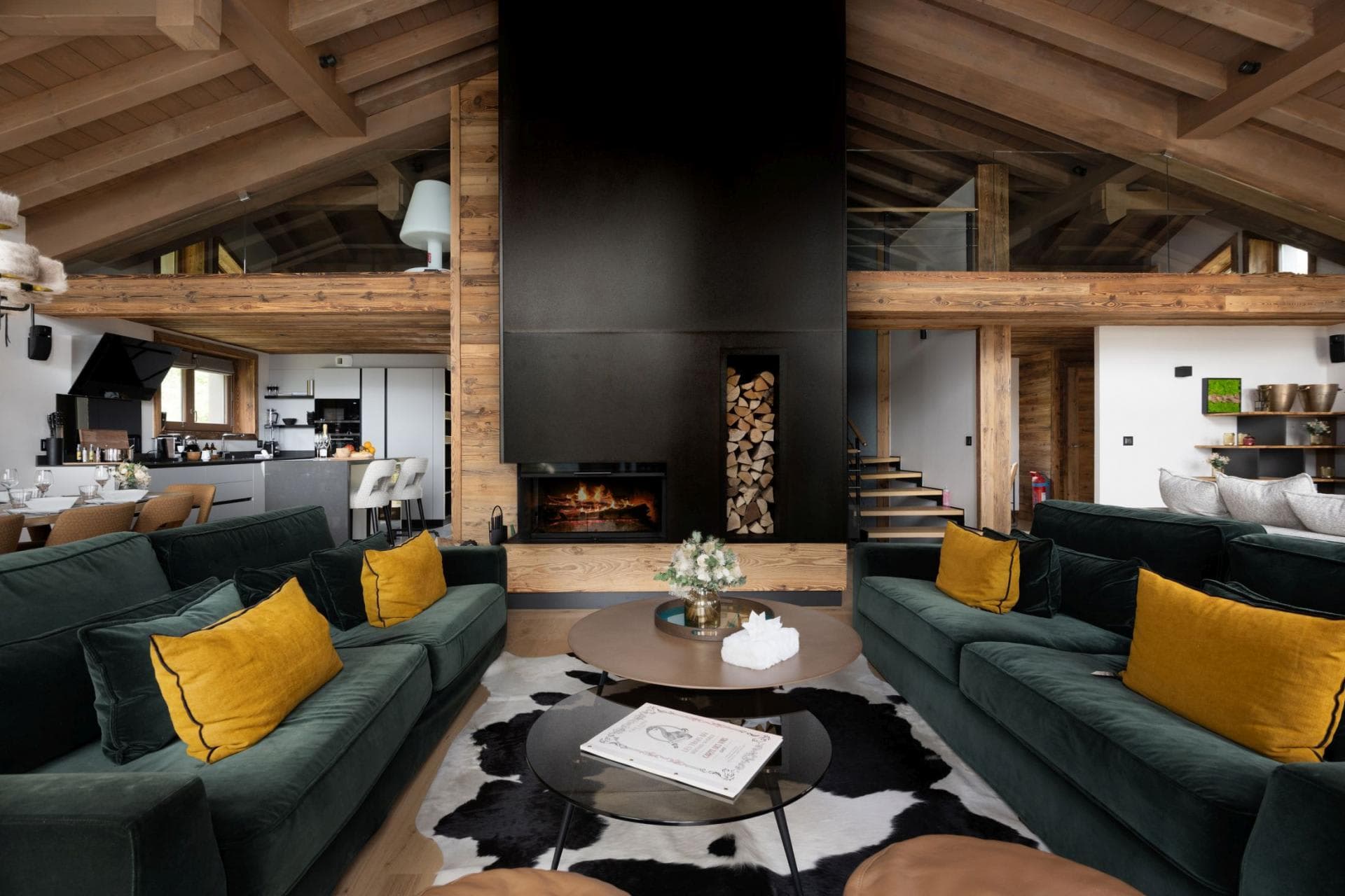 Open-plan living area with wood-burning fireplace and mezzanine loft view