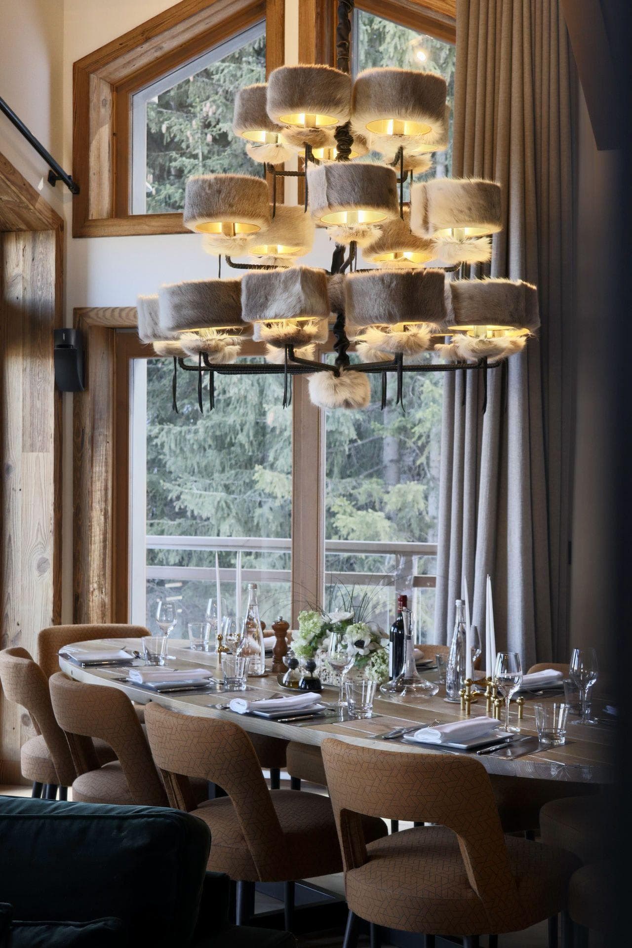 Dining area seats 8; floor-to-ceiling windows with forest views
