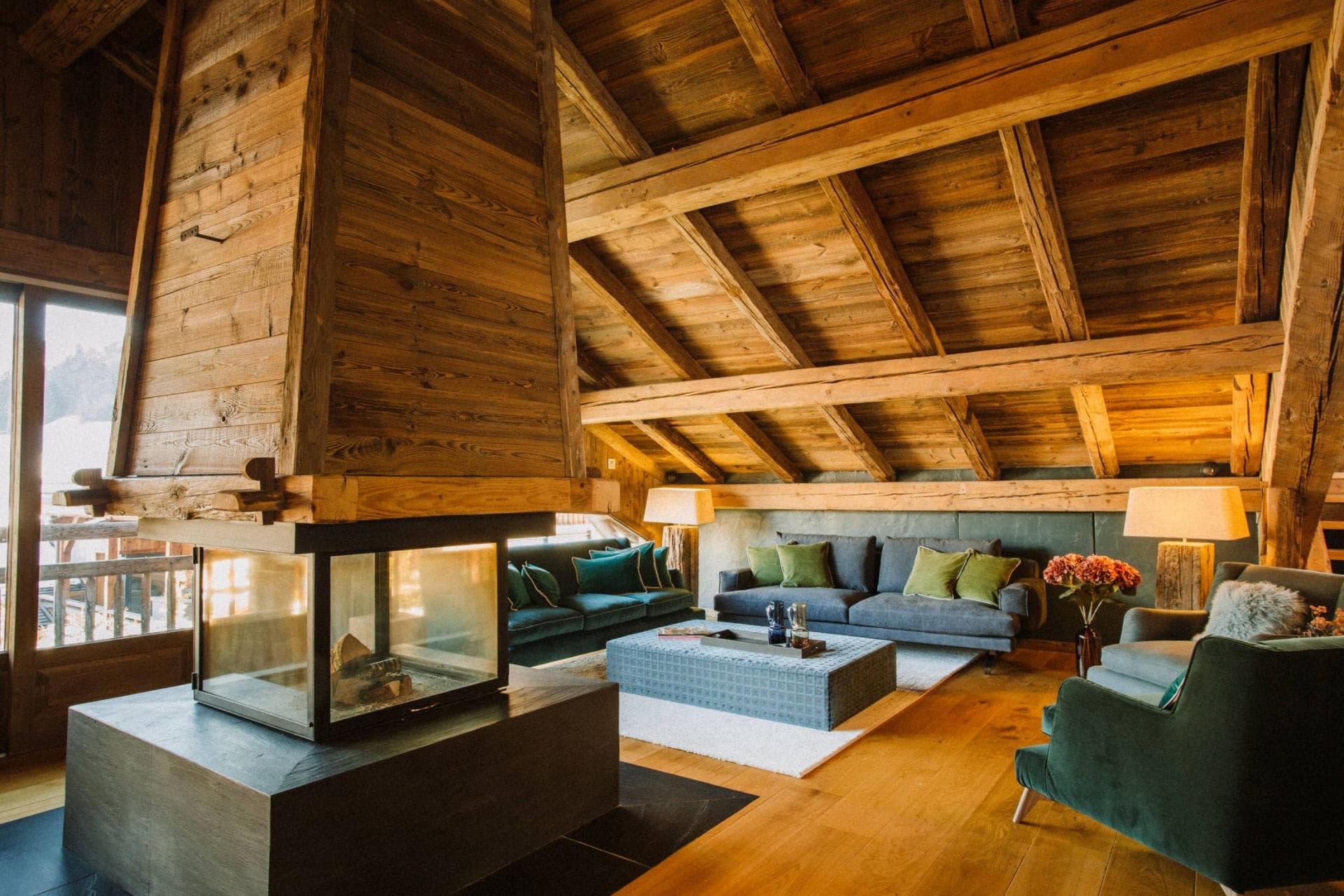Living room with glass-enclosed fireplace and vaulted timber ceilings