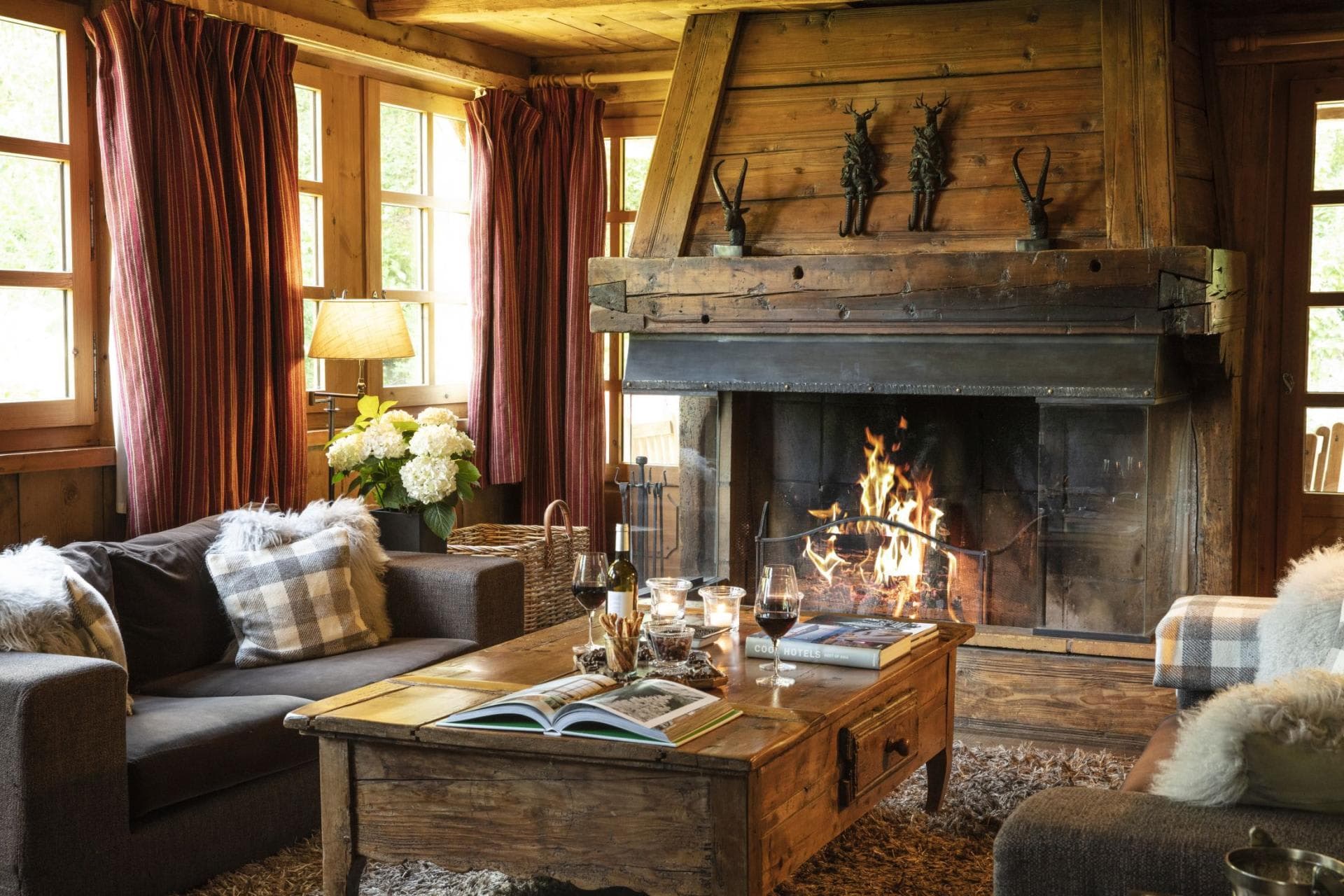Living room with wood-burning fireplace and timber-clad walls