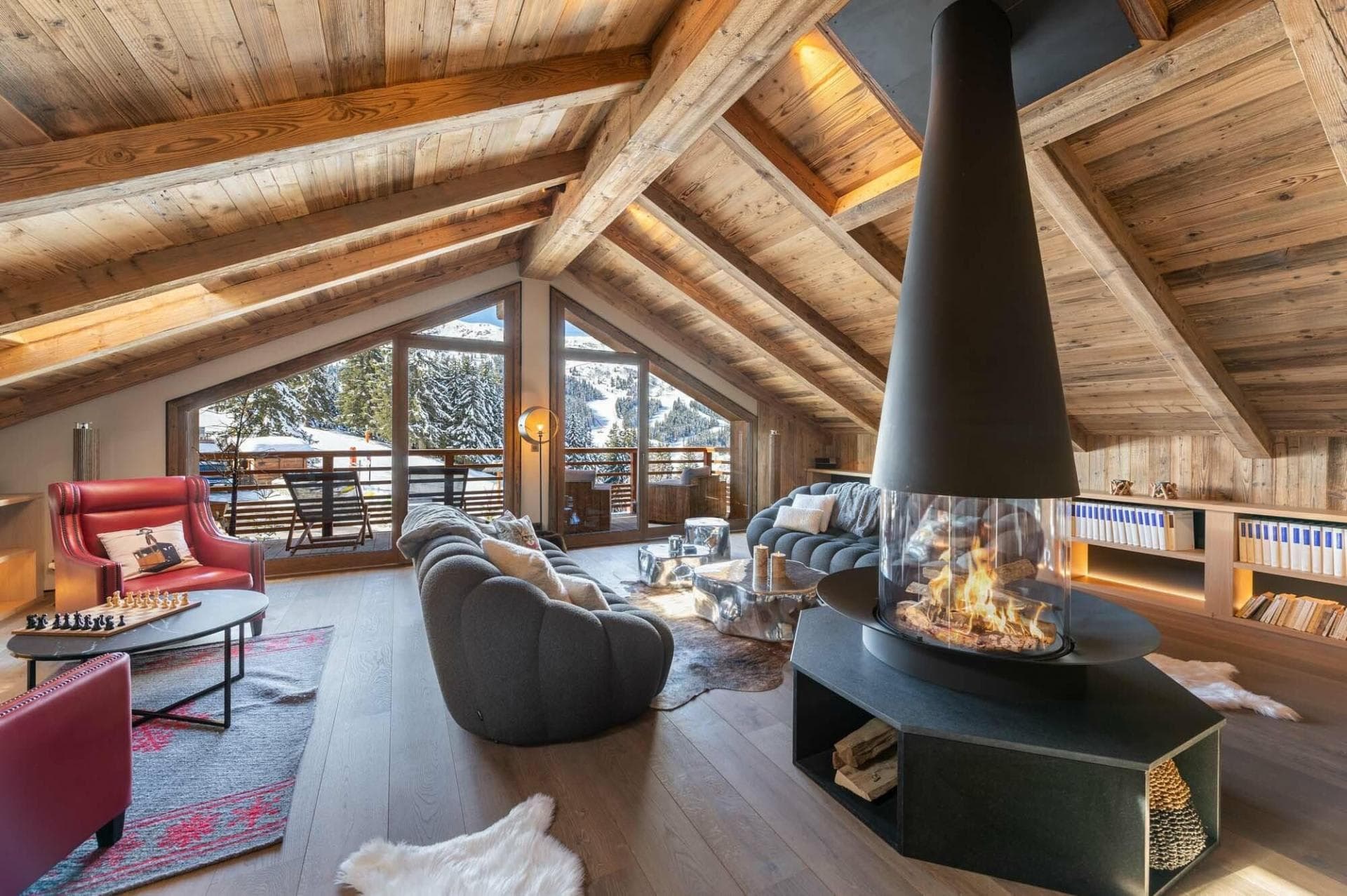 Top floor living area with 360-degree fireplace and ski slope views