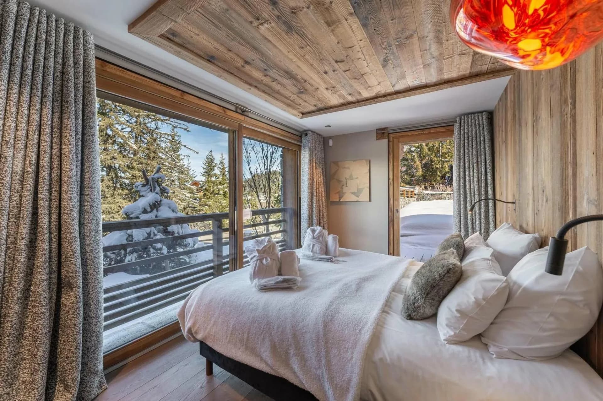 Double bedroom with a private balcony and forest views