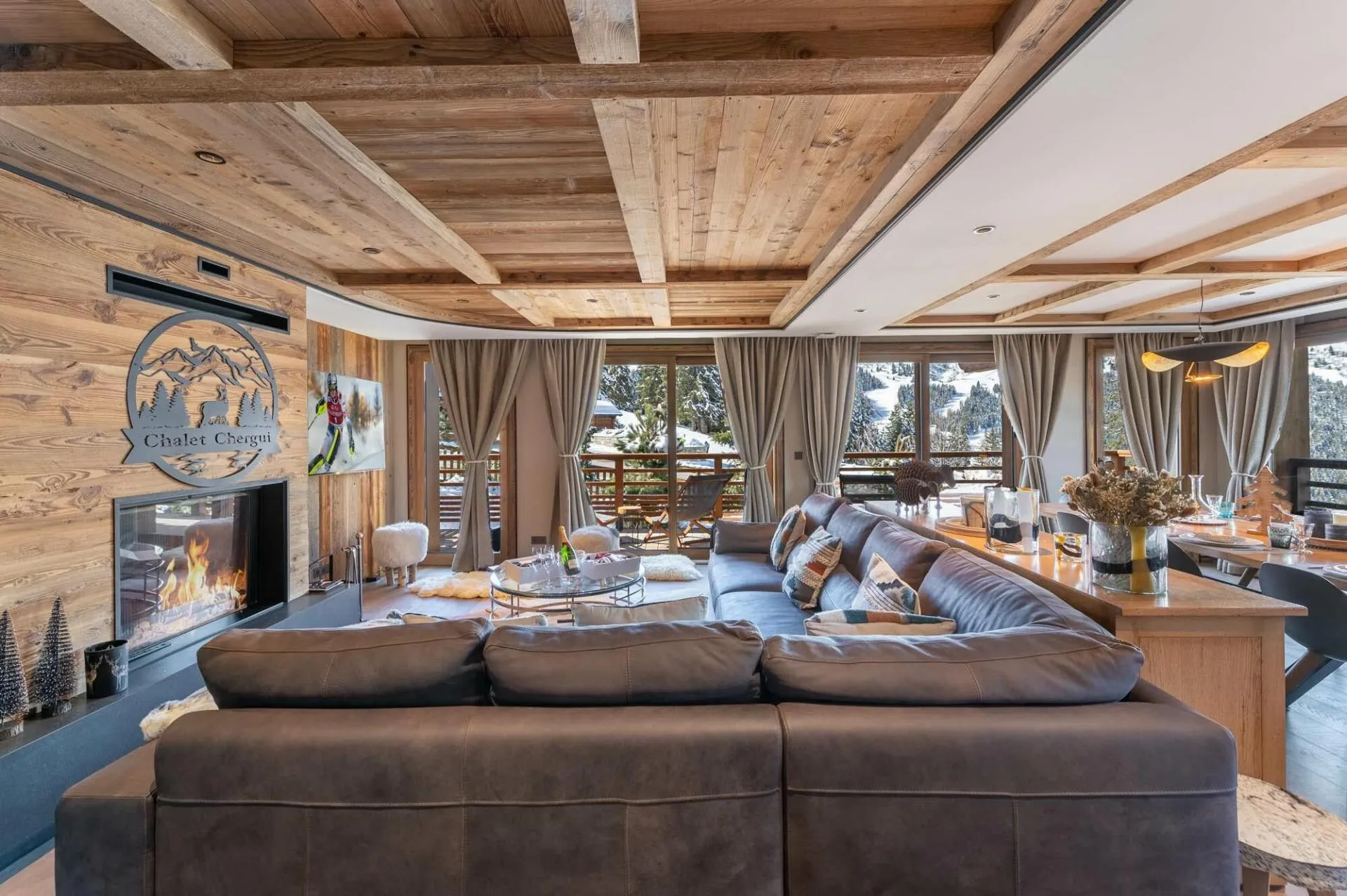 Main lounge with fireplace, dining area and balcony doors