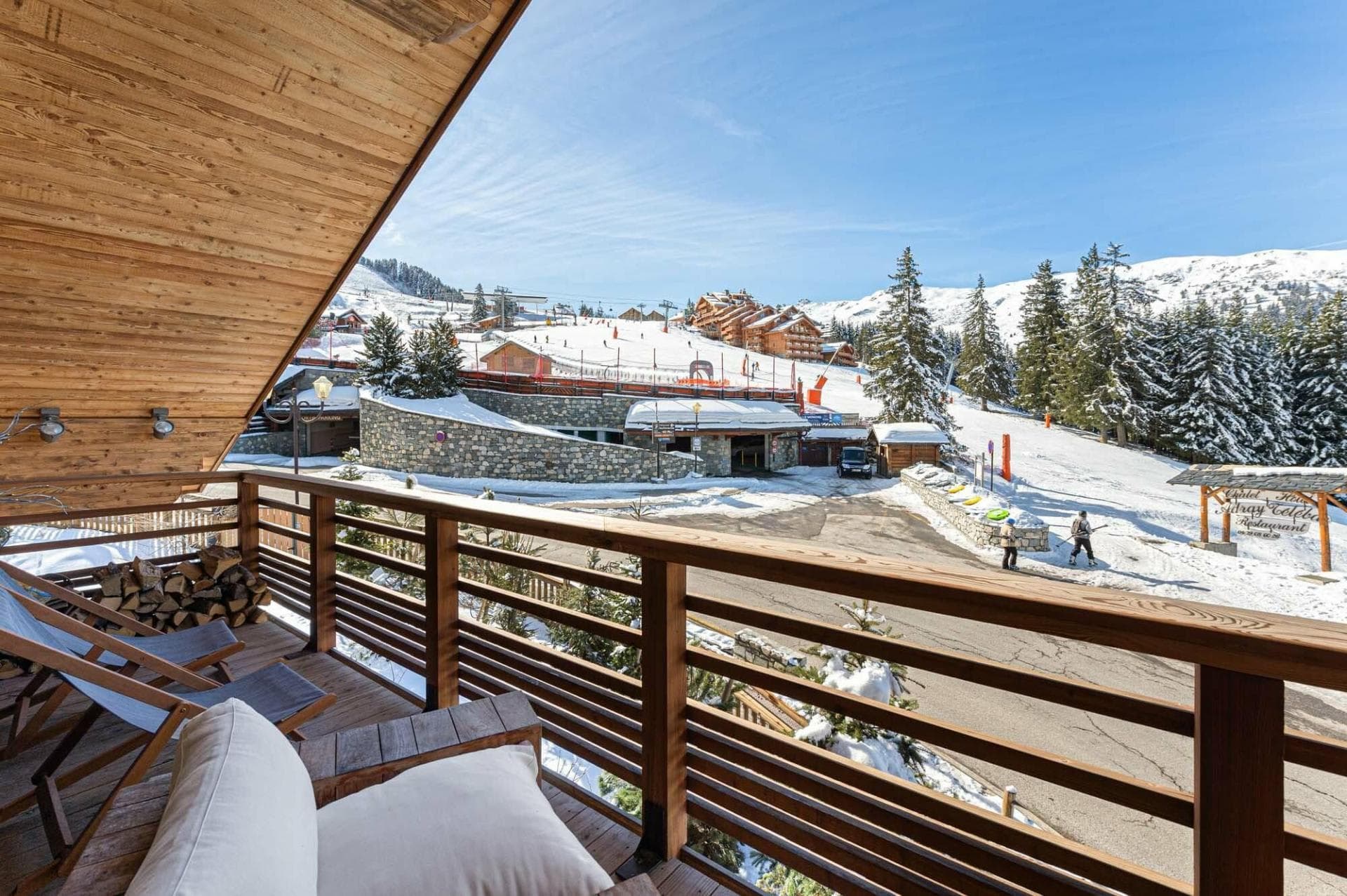 Covered balcony with lounge seating and ski-in/ski-out access views