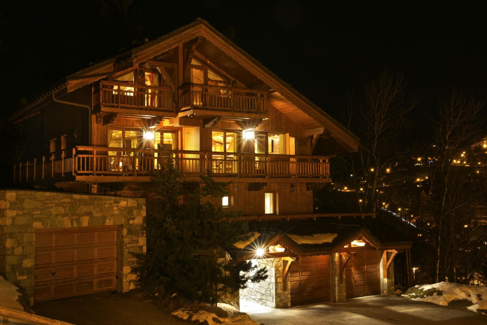 Chalet exterior with three-car garage and wrap-around balconies