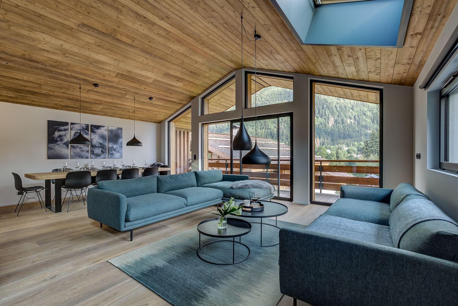 Open-plan living area with vaulted wood ceilings and dining seating for 10