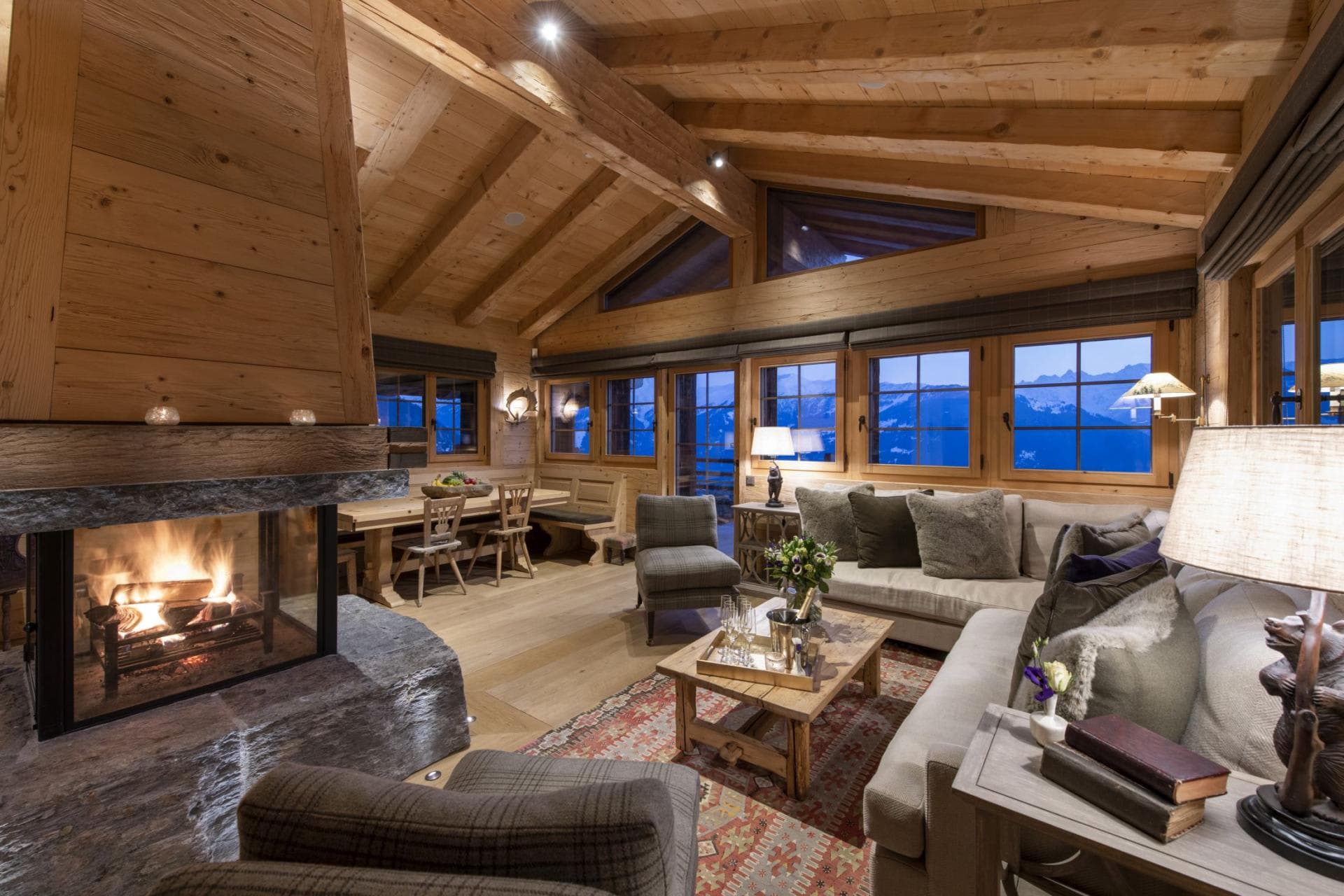 Living room with wood-burning fireplace and mountain views