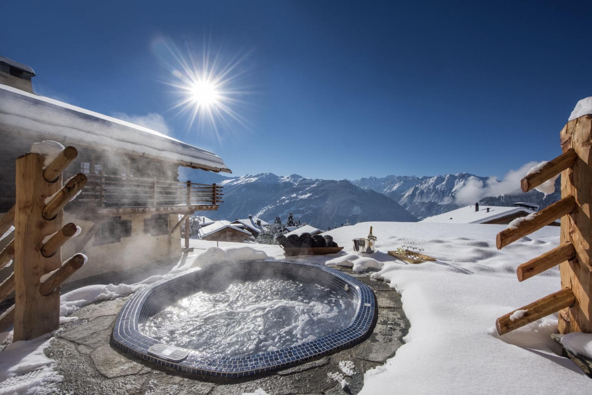 Sunken hot tub with mosaic tile and panoramic mountain views