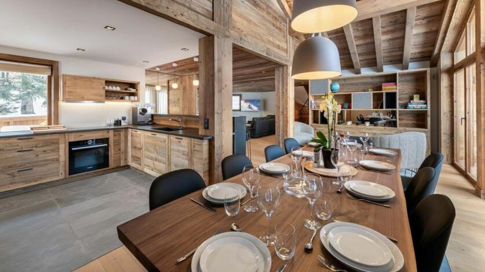 Open-plan dining area and kitchen with espresso machine and seating for 10