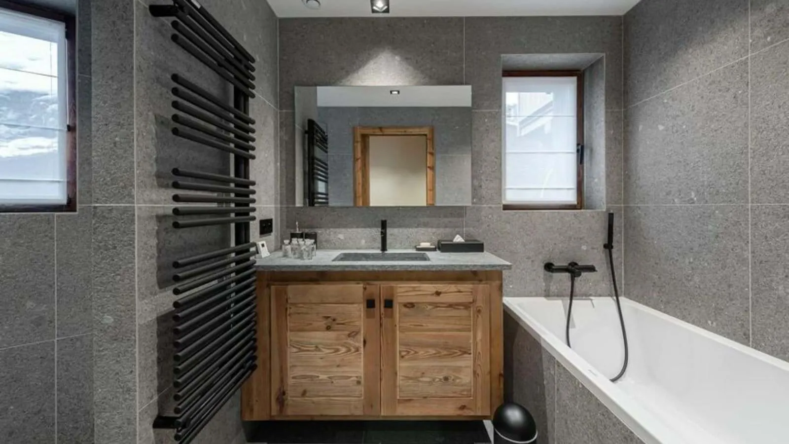 En-suite bathroom with a bathtub and heated towel rail